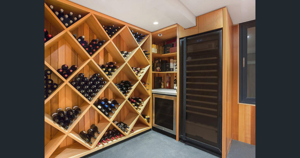 Architectural wine cellar in a custom Gold Coast home by All Round Building Services